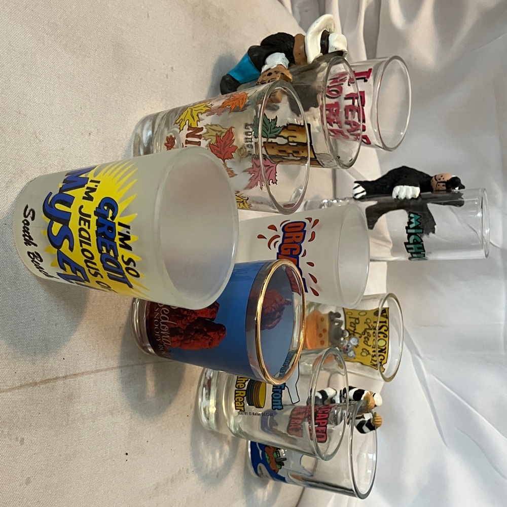 Set of 10 various sizes n shapes shot glasses from various cities with